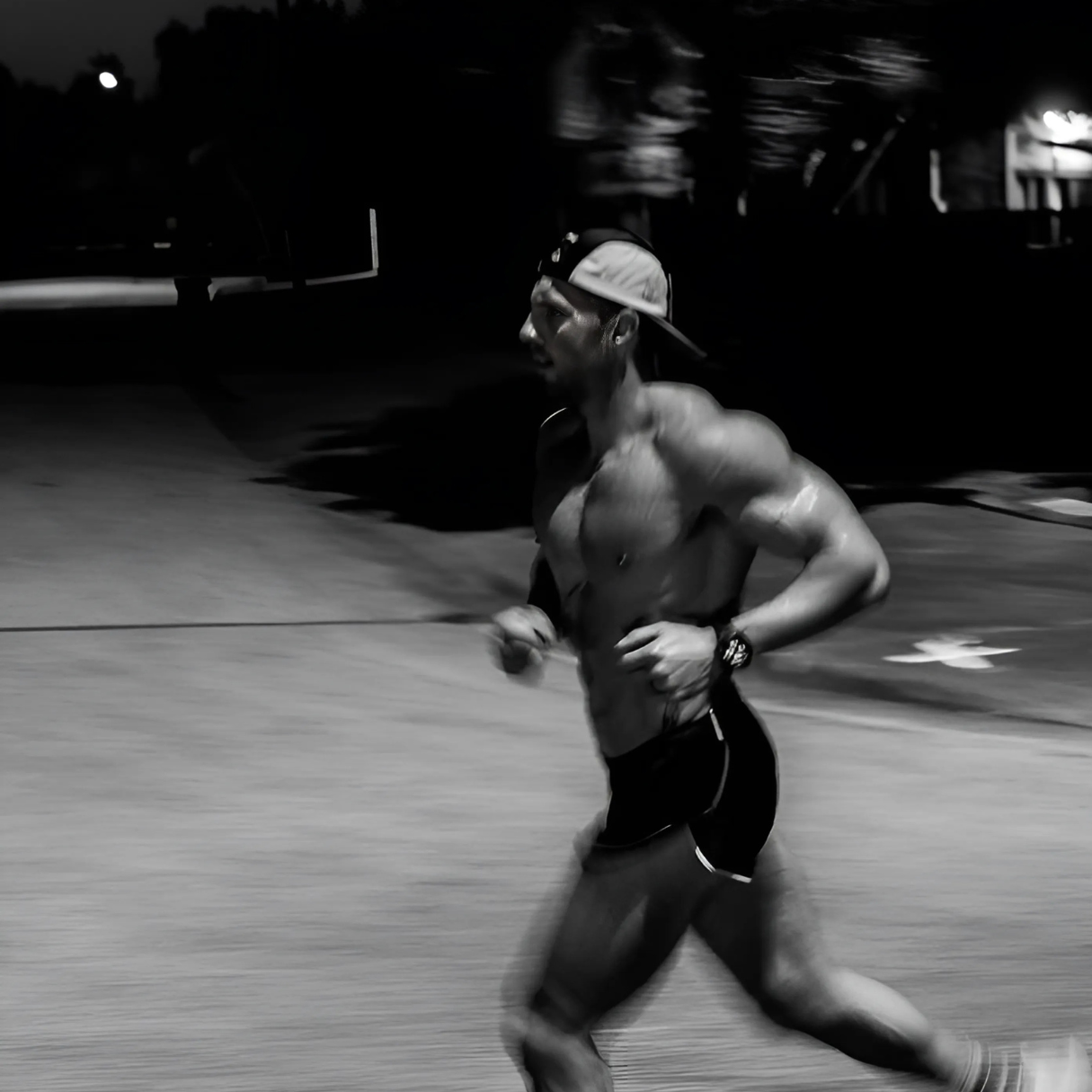 man running in black and white looking strong and confident in SRPNT active wear